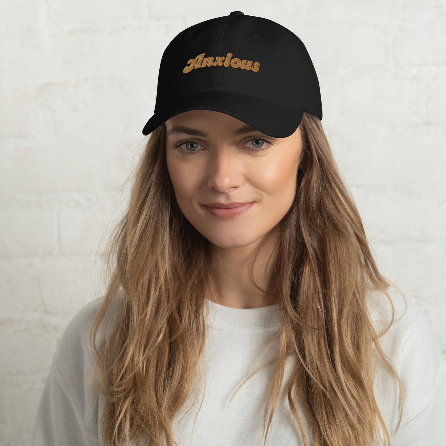 Portland city editions with “Anxious” type in gold embroidery on black casual dad hat front view on female model