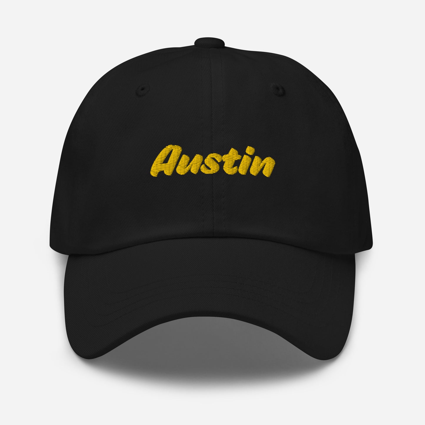 Austin city editions with “Austin” type in yellow embroidery on black casual dad hat front view on white background