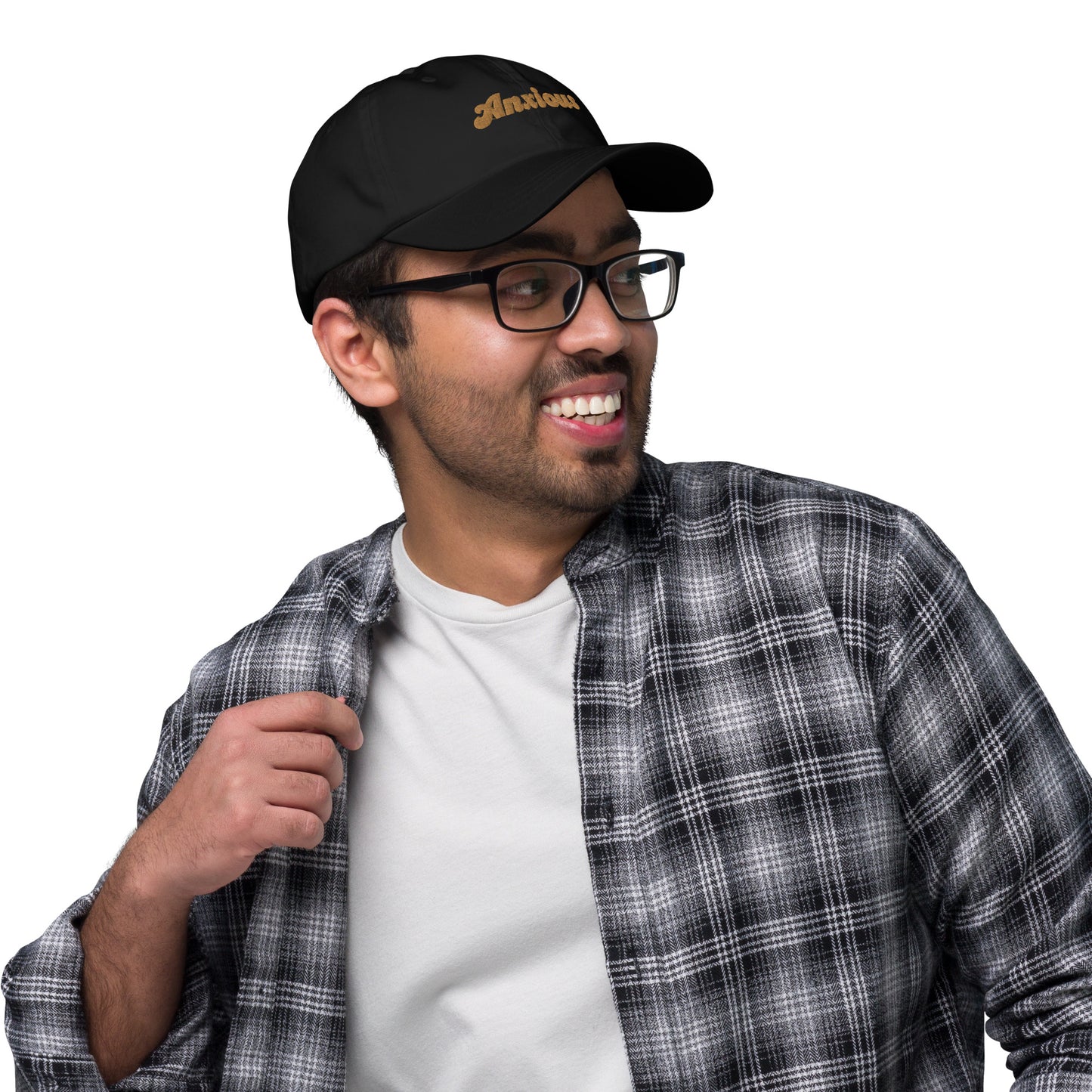 Portland city editions with “Anxious” type in gold embroidery on black casual dad hat front view on male model