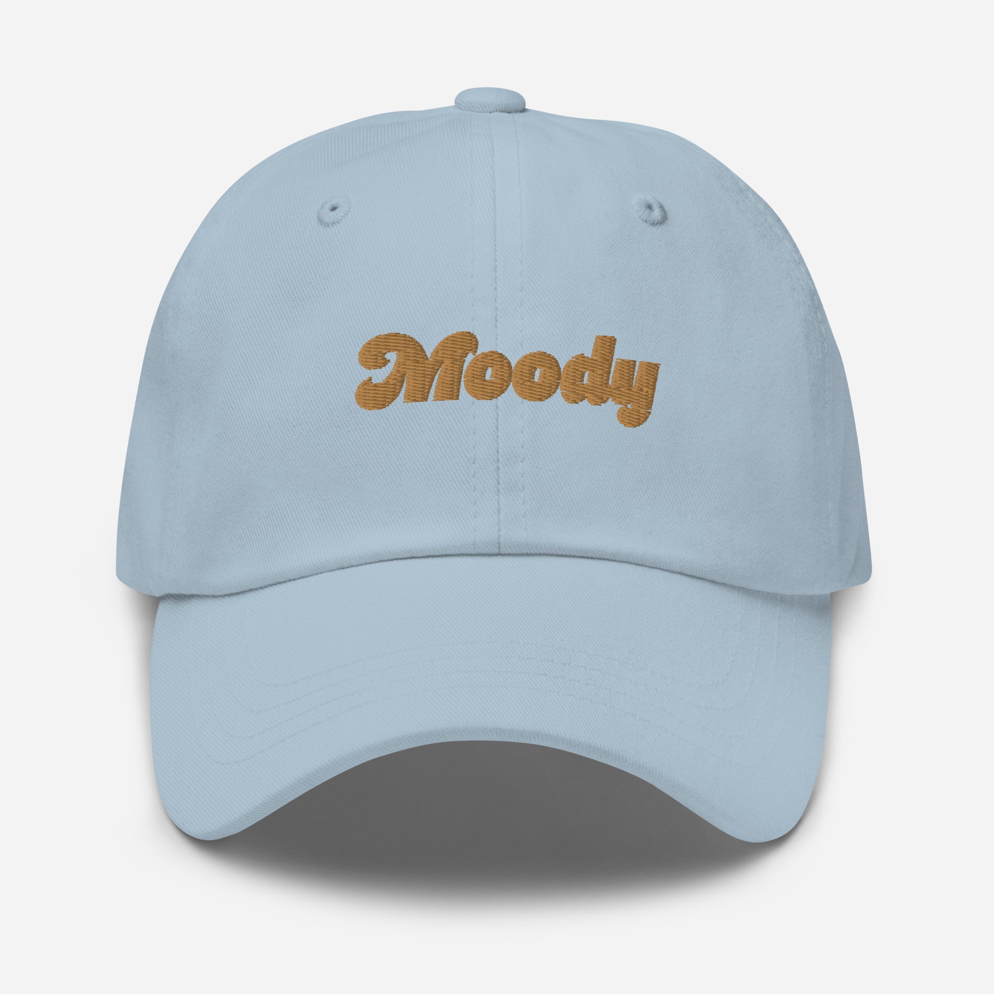Portland city editions with “Moody” type in gold embroidery on light blue casual dad hat front view on white background
