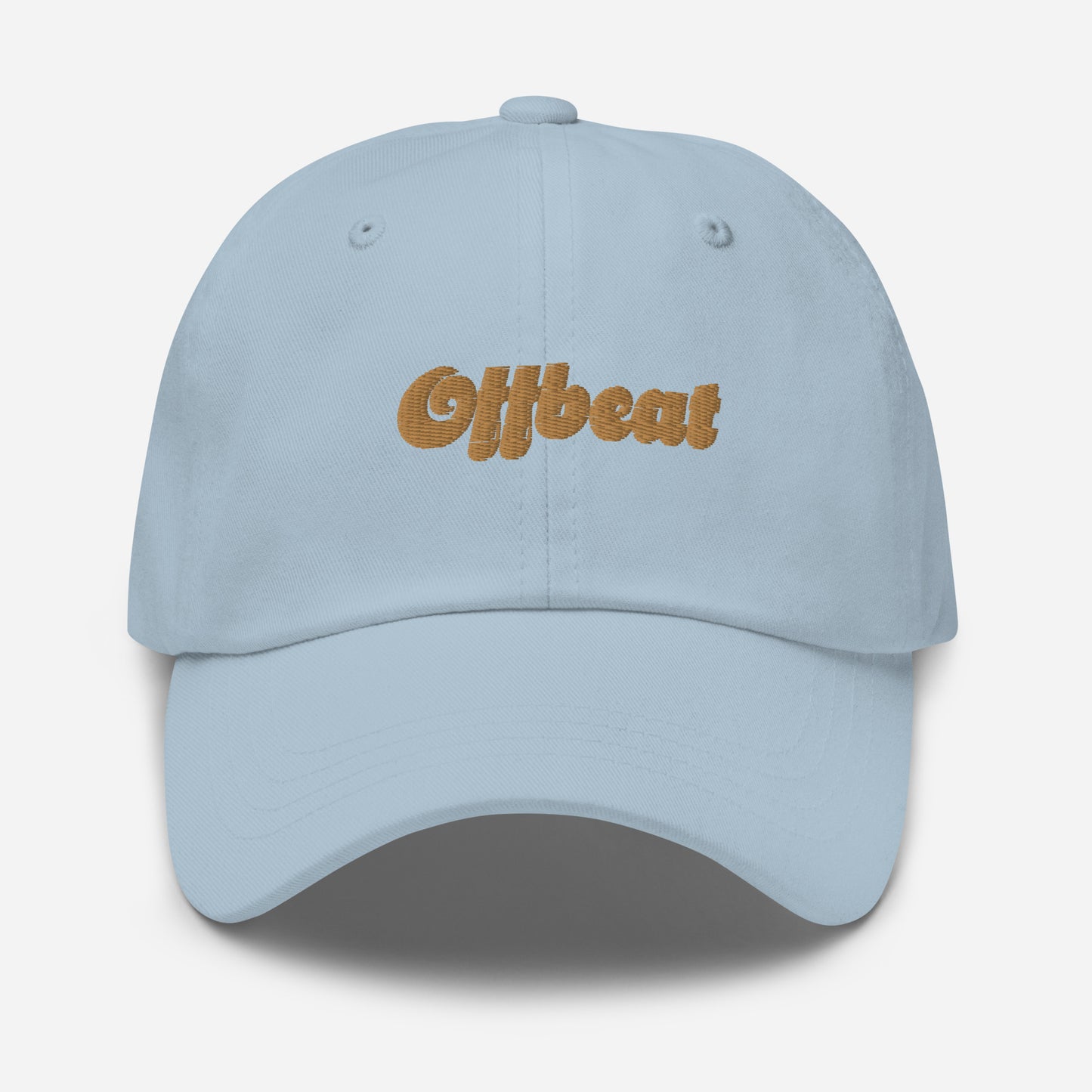 Portland city editions with “Offbeat” type in gold embroidery on light blue casual dad hat front view on white background