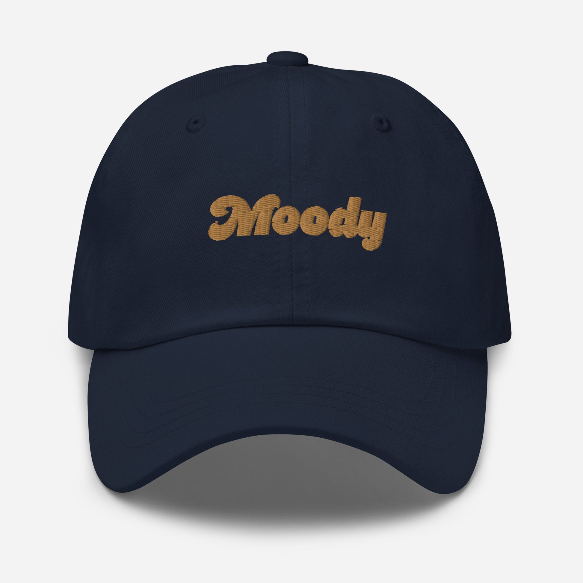 Portland city editions with “Moody” type in gold embroidery on navy casual dad hat front view on white background