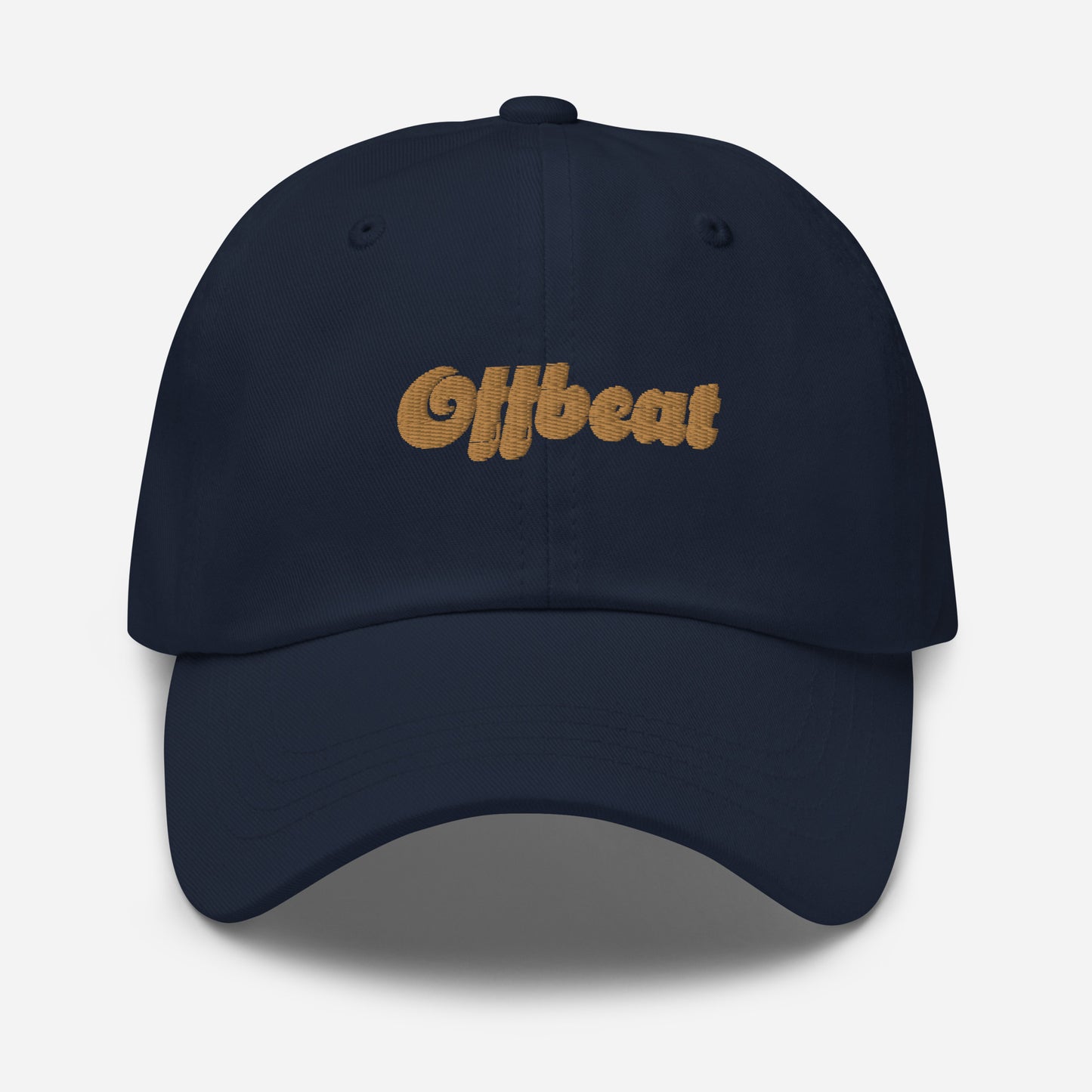 Portland city editions with “Offbeat” type in gold embroidery on navy casual dad hat front view on white background