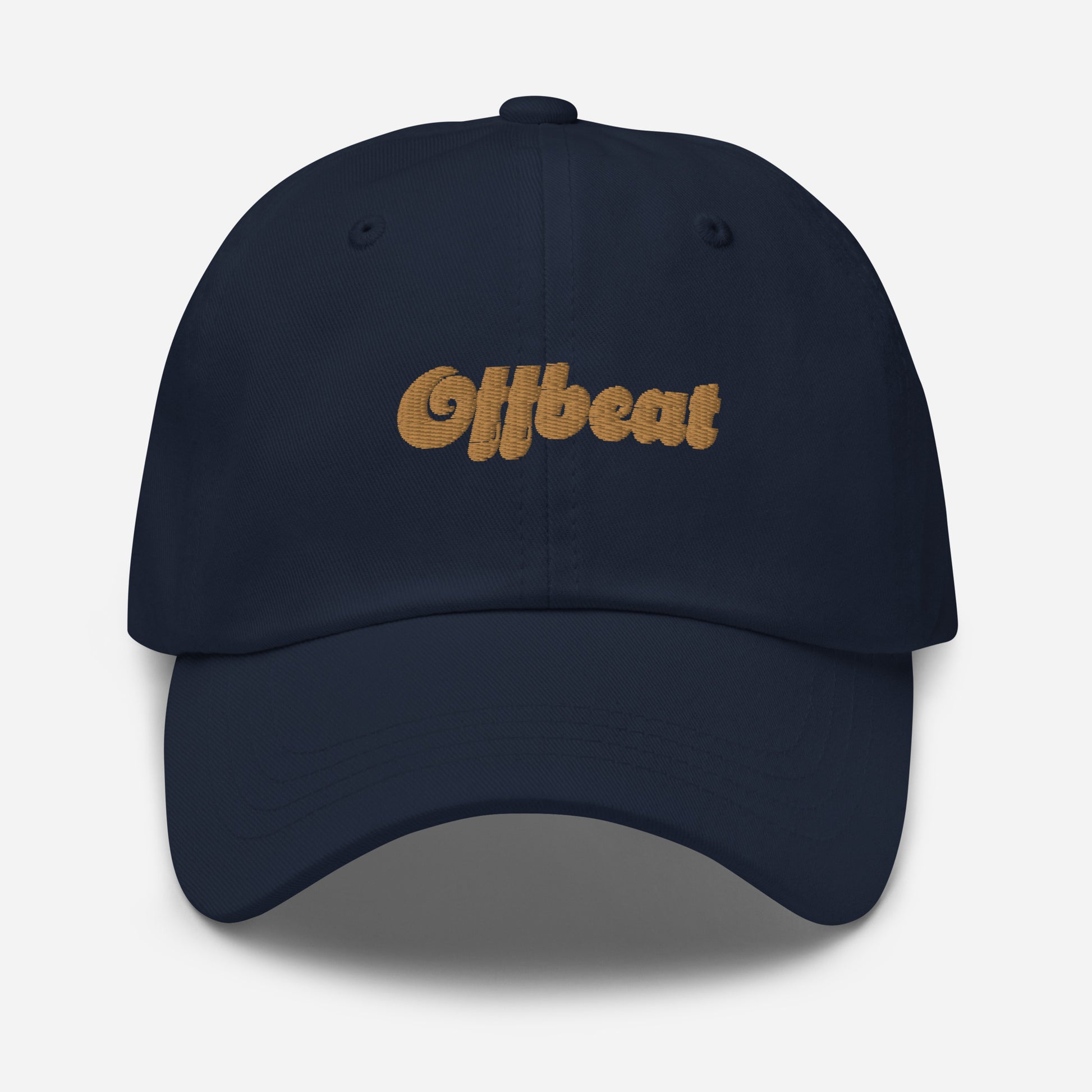 Portland city editions with “Offbeat” type in gold embroidery on navy casual dad hat front view on white background