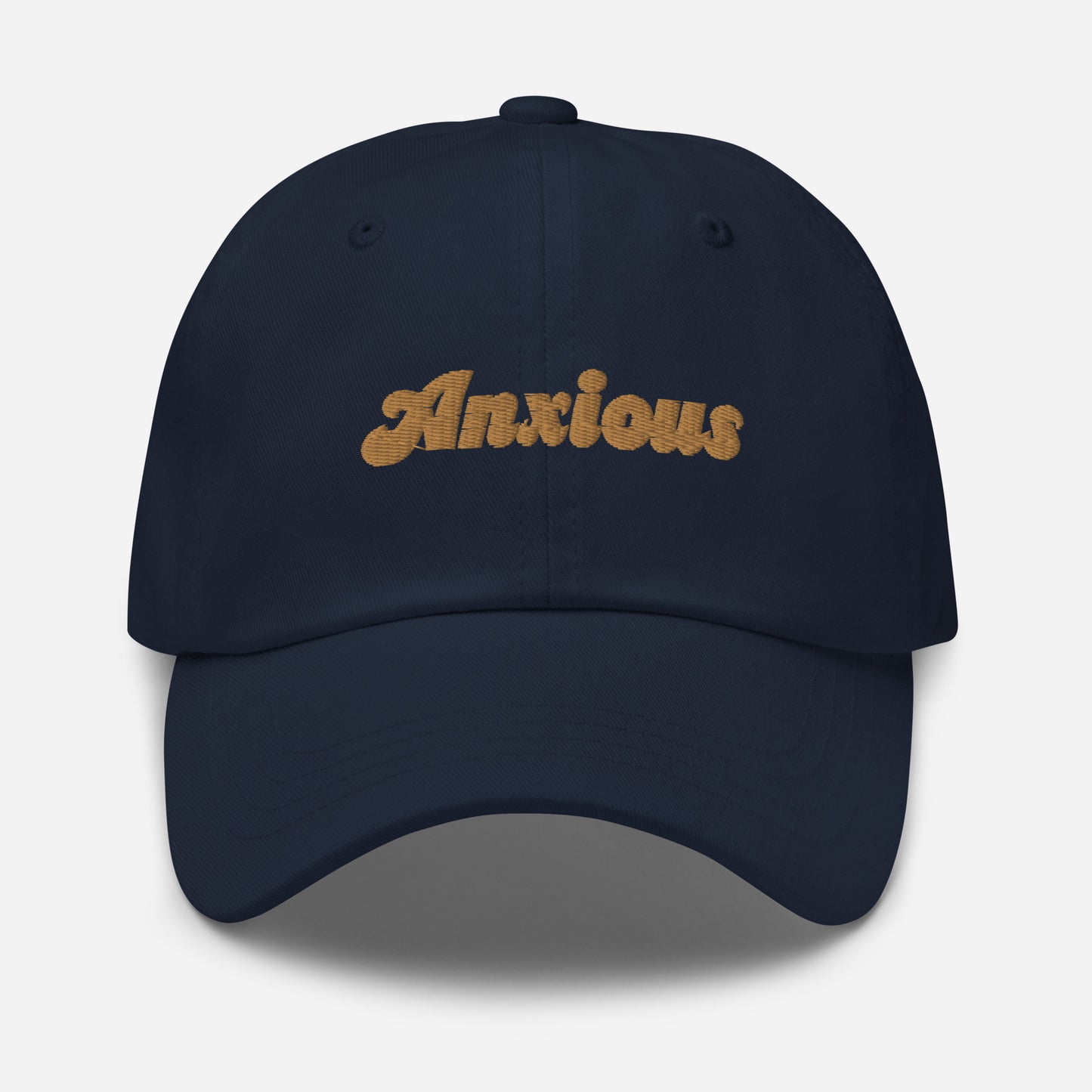 Portland city editions with “Anxious” type in gold embroidery on navy casual dad hat front view on white background