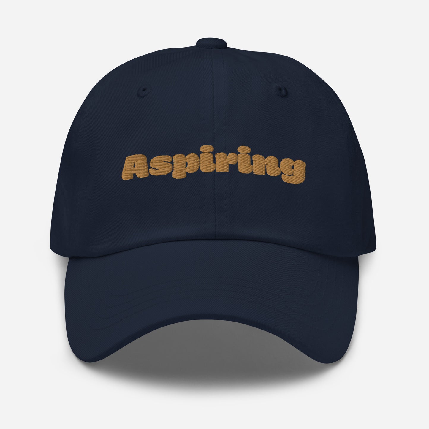 Los Angeles city editions with “Aspiring” type in gold embroidery on navy casual dad hat front view on white background