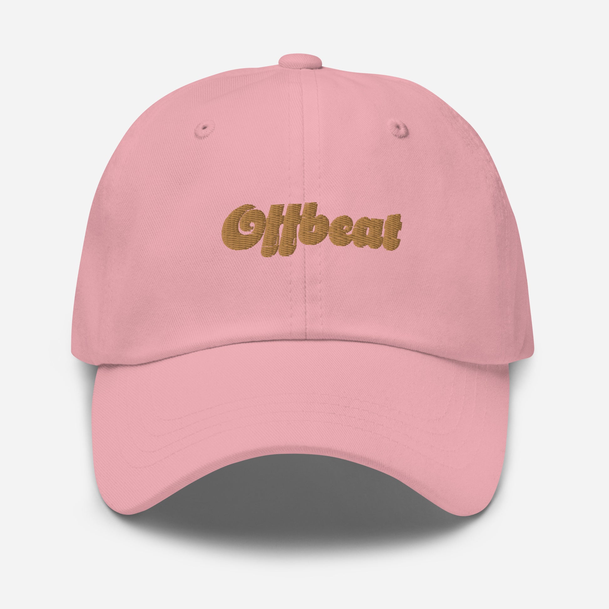 Portland city editions with “Offbeat” type in gold embroidery on pink casual dad hat front view on white background