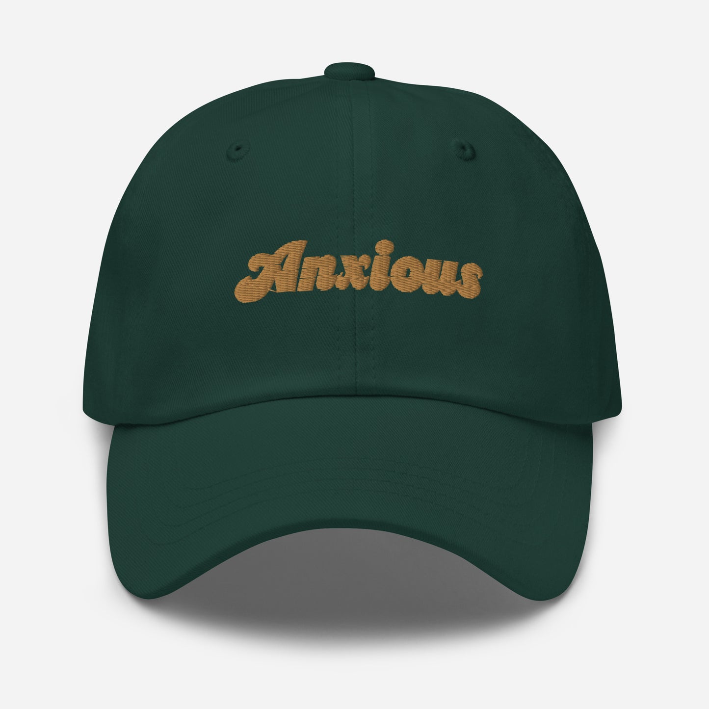 Portland city editions with “Anxious” type in gold embroidery on green casual dad hat front view on white background