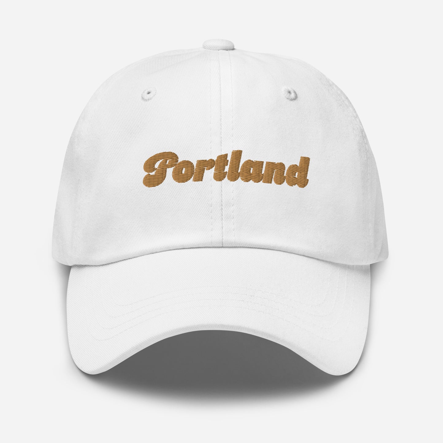 Portland city editions with “Portland” type in gold embroidery on white casual dad hat front view on white background