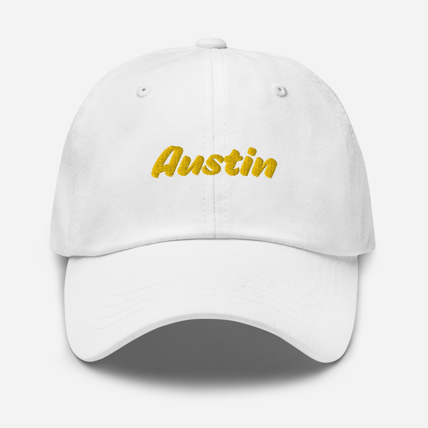 Austin city editions with “Austin” type in yellow embroidery on white casual dad hat front view on white background