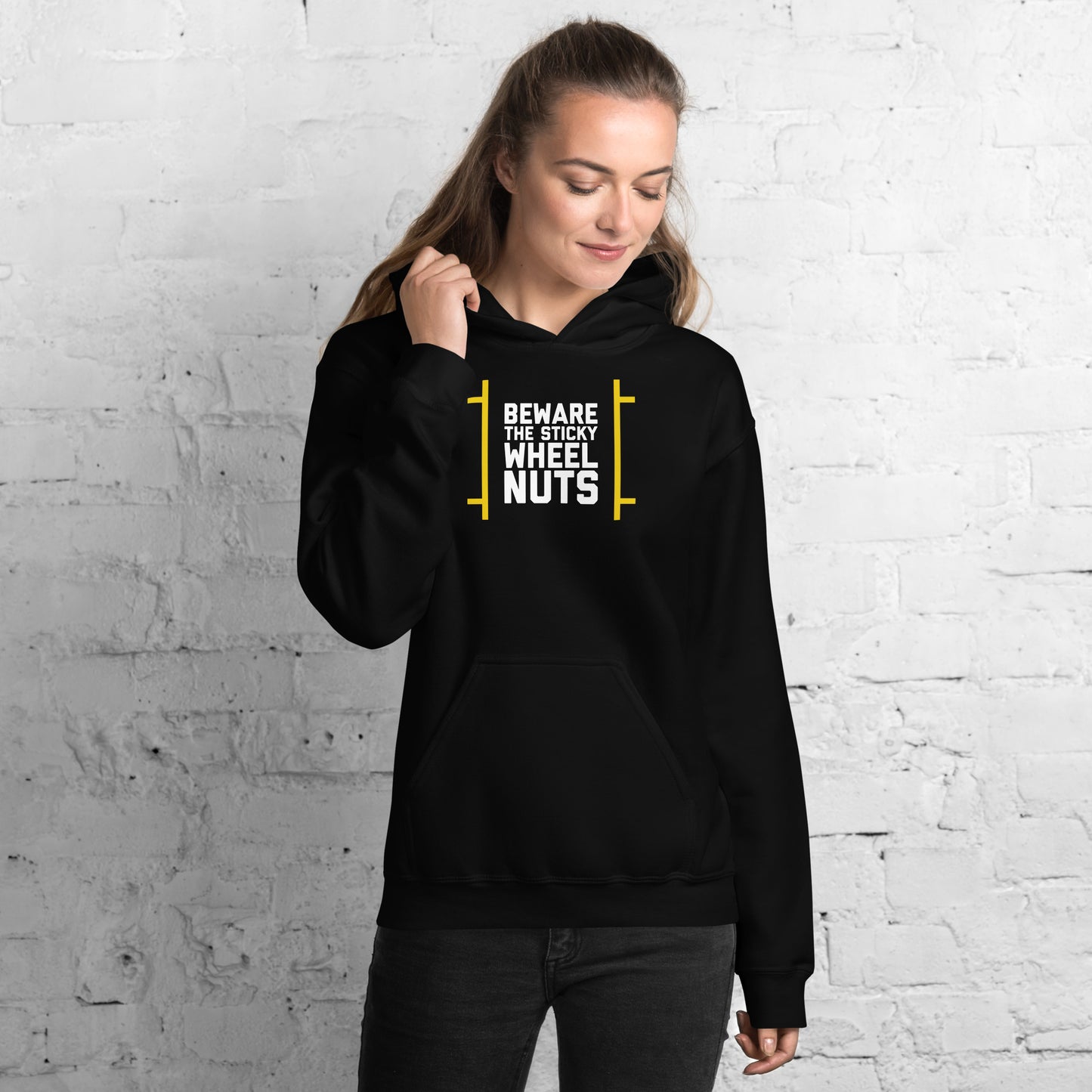 Beware The Sticky Wheel Nuts text on black hoodie, front view on female model looking down