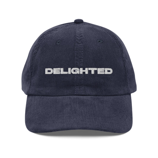 DELIGHTED, text, type, hat, dad hat, corduroy, cozy, design. front view of blue hat on white background