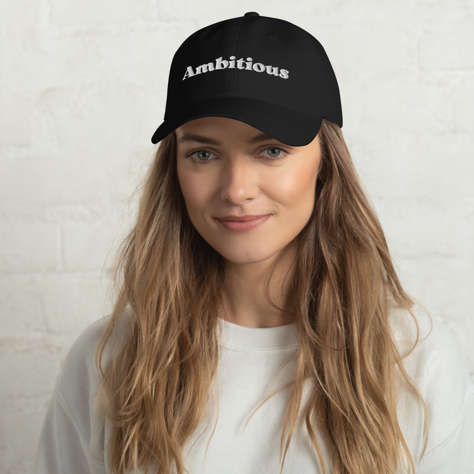 New York city editions with “Ambitious” type in white embroidery on black casual dad hat front view on female model