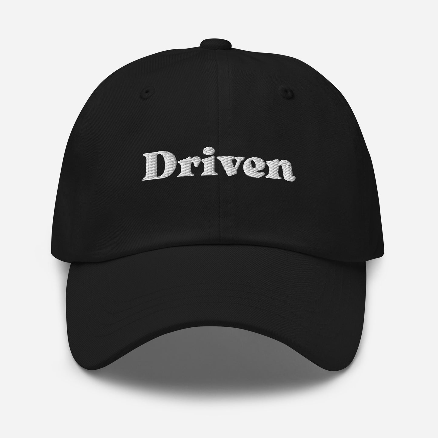 New York city editions with “Driven” type in white embroidery on black casual dad hat front view on white background