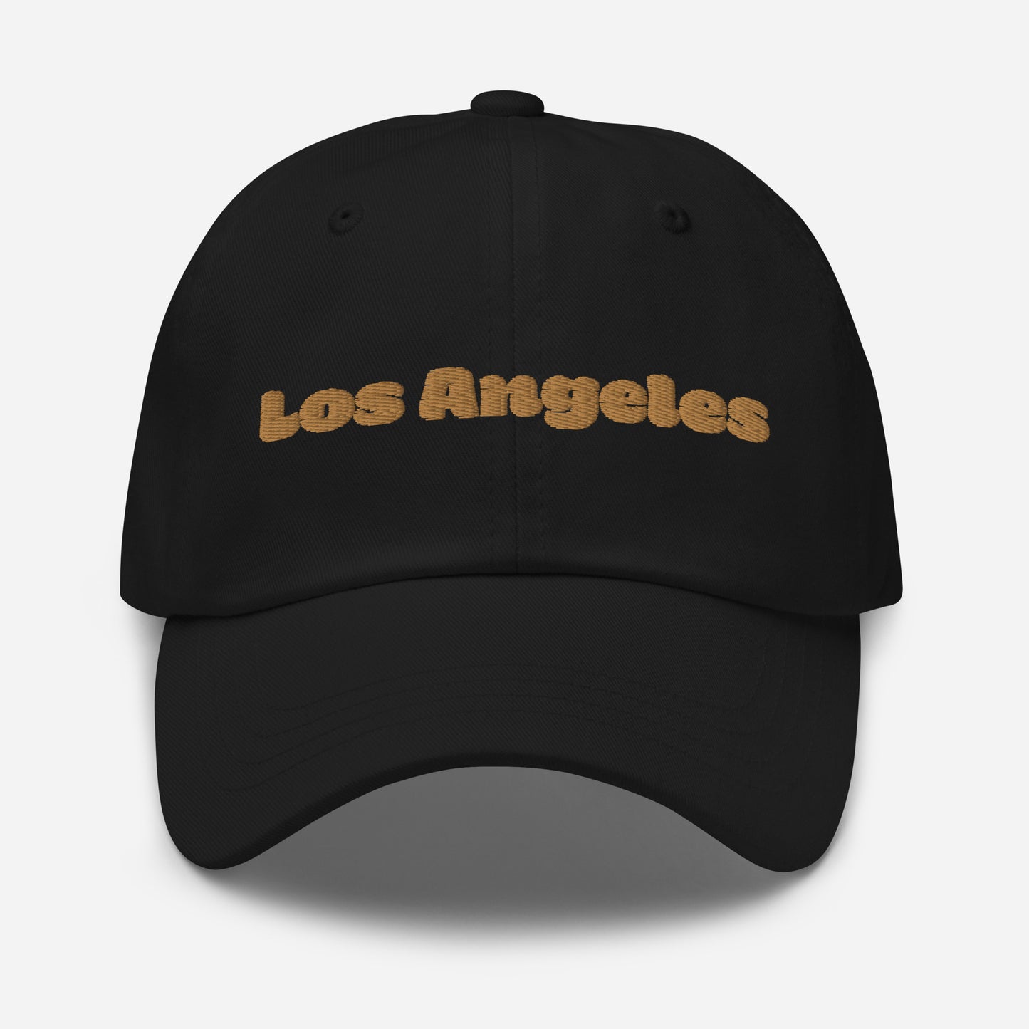 Los Angeles city editions with “Los Angeles” type in gold embroidery on black casual dad hat front view on white background