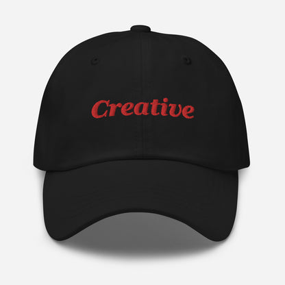 London city editions with “Creative” type in red embroidery on black casual dad hat front view on white background