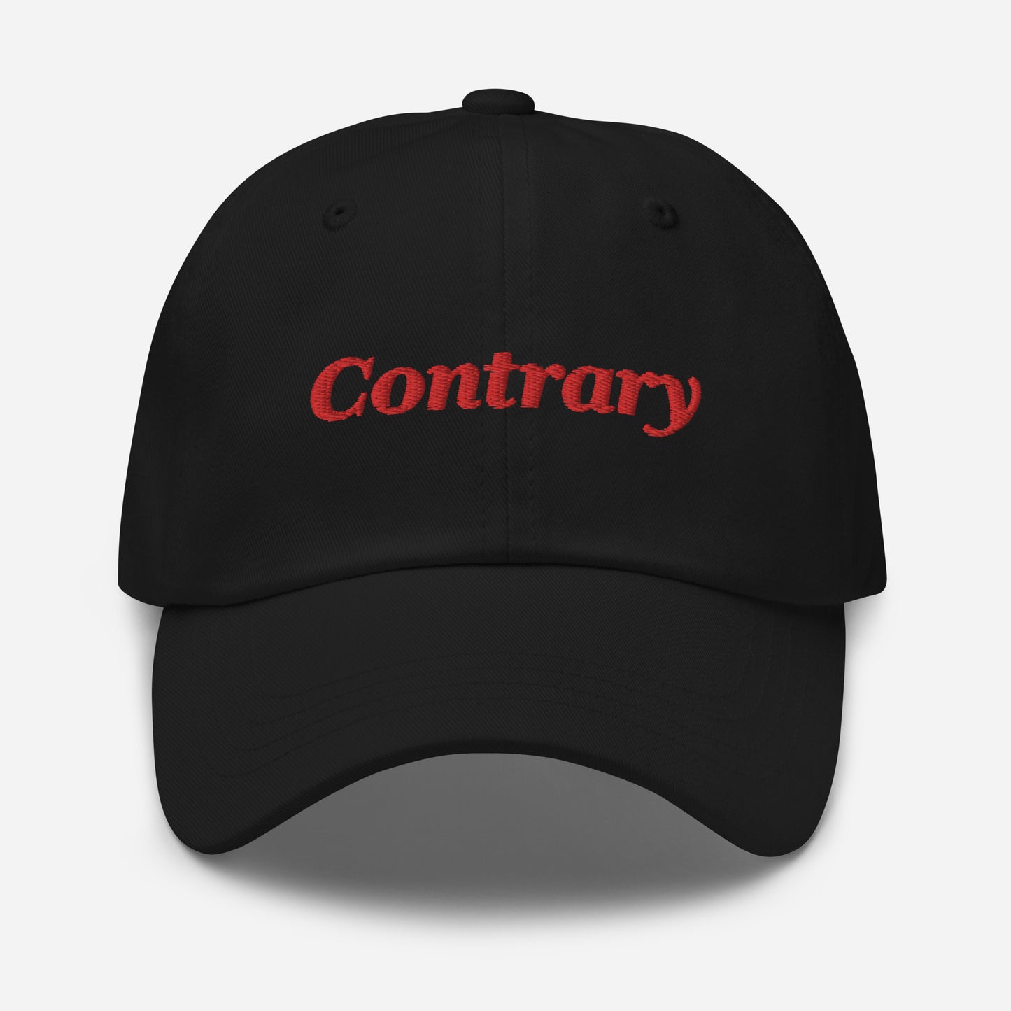 London city editions with “Contrary” type in red embroidery on black casual dad hat front view on white background