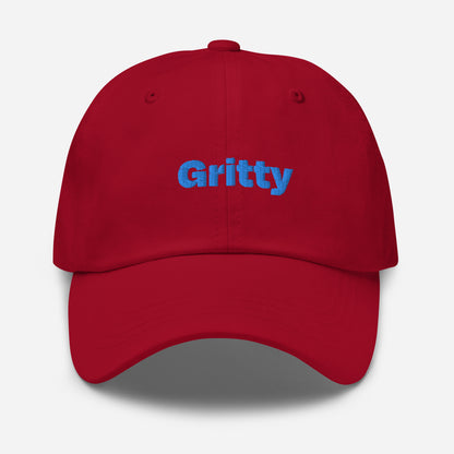 Chicago city editions with “Gritty” type in blue embroidery on red casual dad hat front view on white background