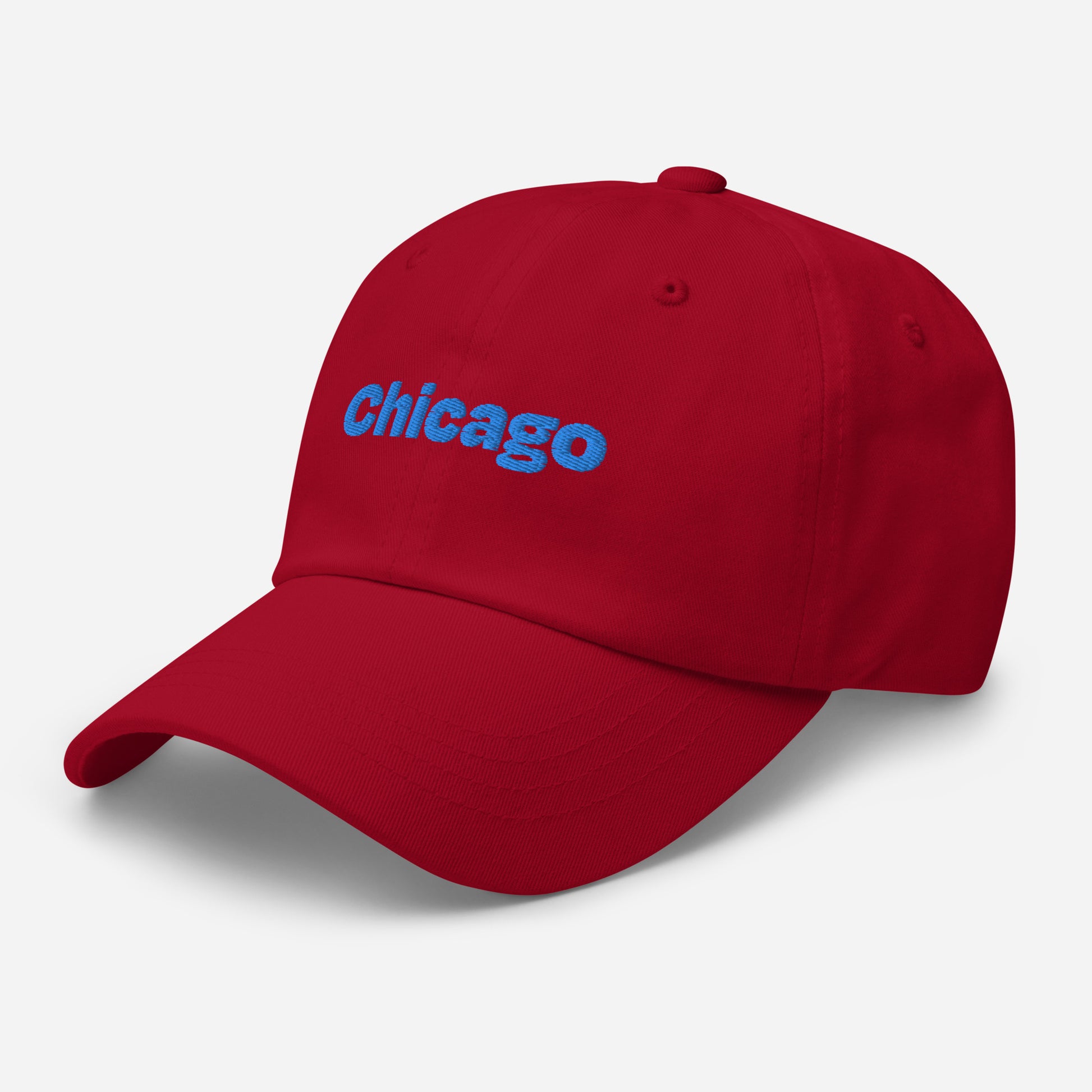 Chicago city editions with “Chicago” type in blue embroidery on red casual dad hat front side view on white background