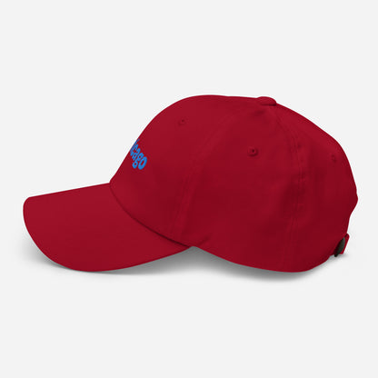 Chicago city editions with “Chicago” type in blue embroidery on red casual dad hat side view on white background