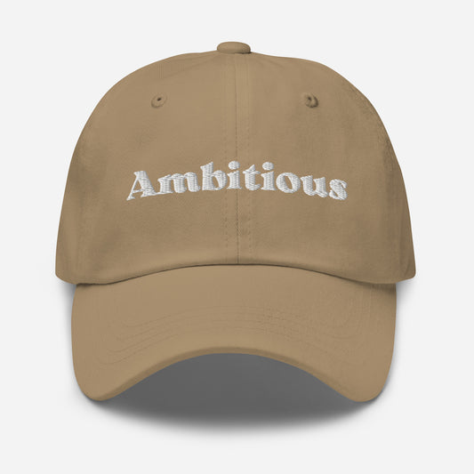 New York city editions with “Ambitious” type in white embroidery on khaki casual dad hat front view on white background