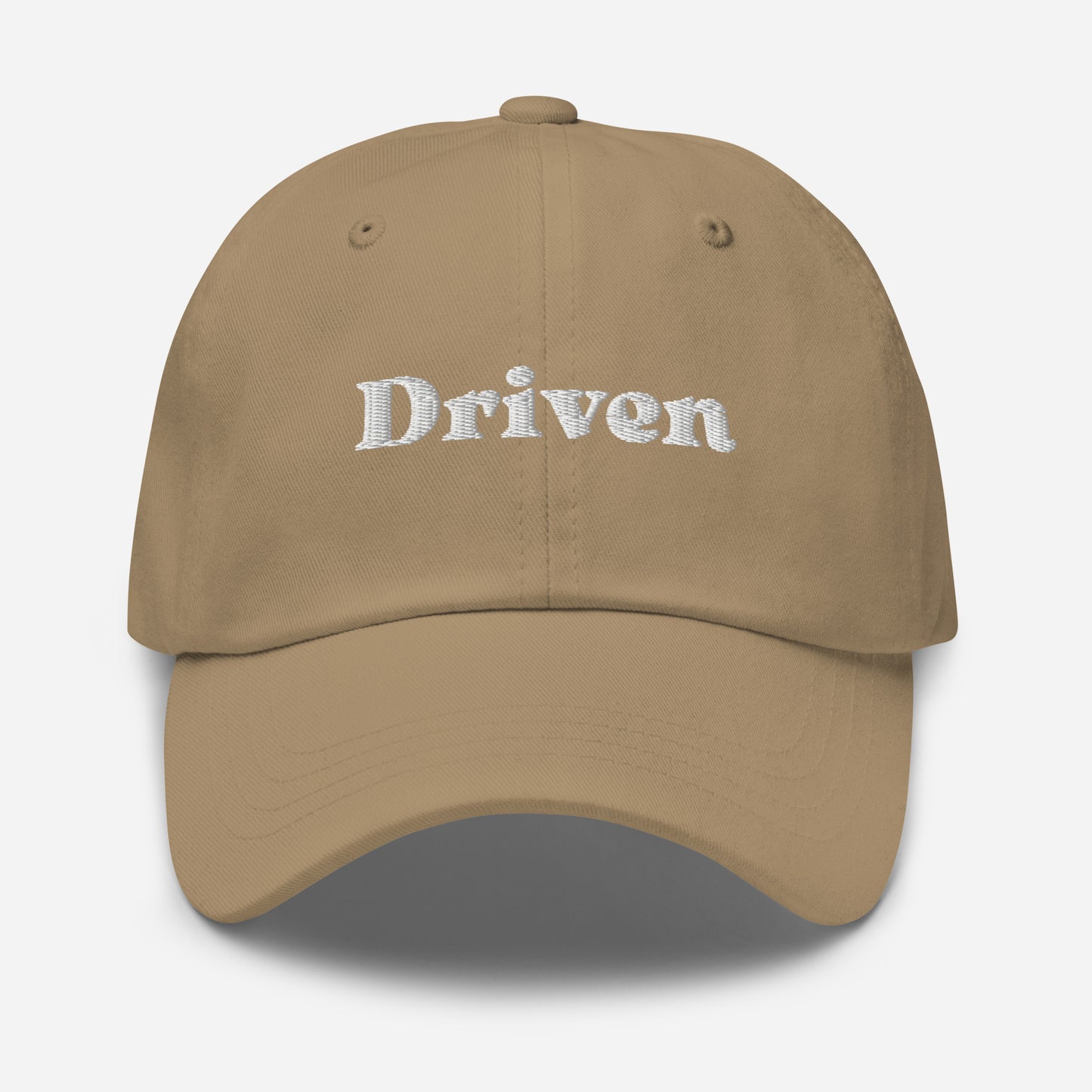 New York city editions with “Driven” type in white embroidery on khaki casual dad hat front view on white background