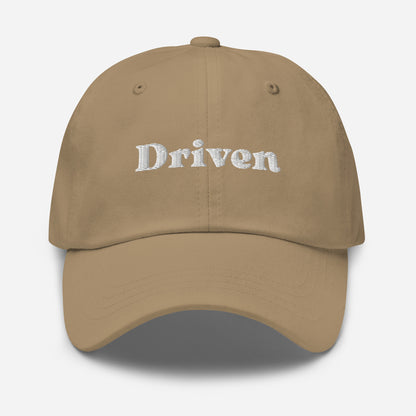 New York city editions with “Driven” type in white embroidery on khaki casual dad hat front view on white background