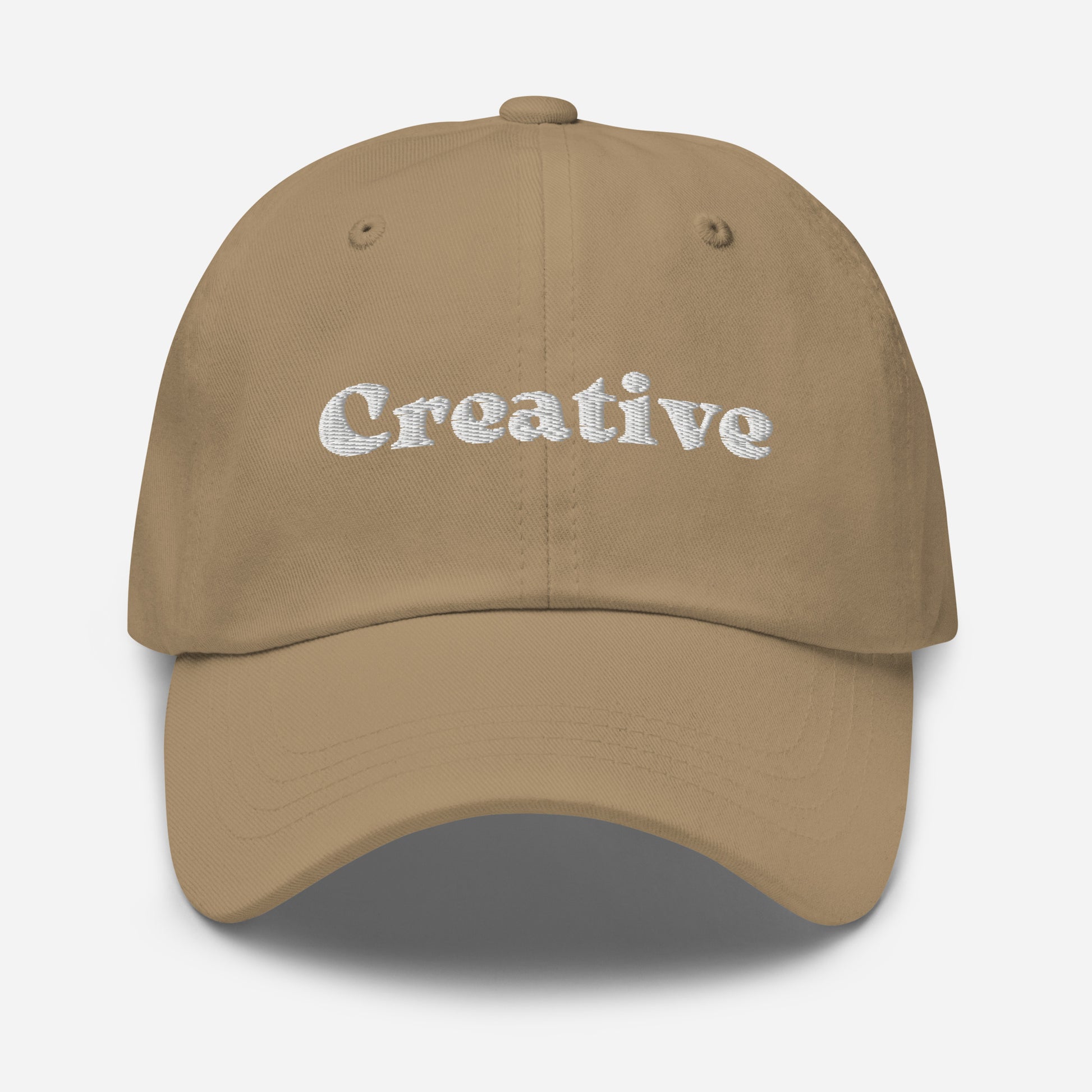 New York city editions with “Creative” type in white embroidery on khaki casual dad hat front view on white background