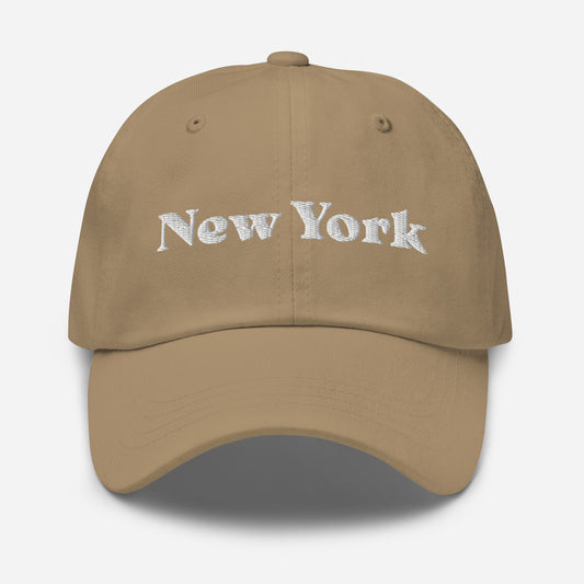 New York city editions with “New York” type in white embroidery on khaki casual dad hat front view on white background