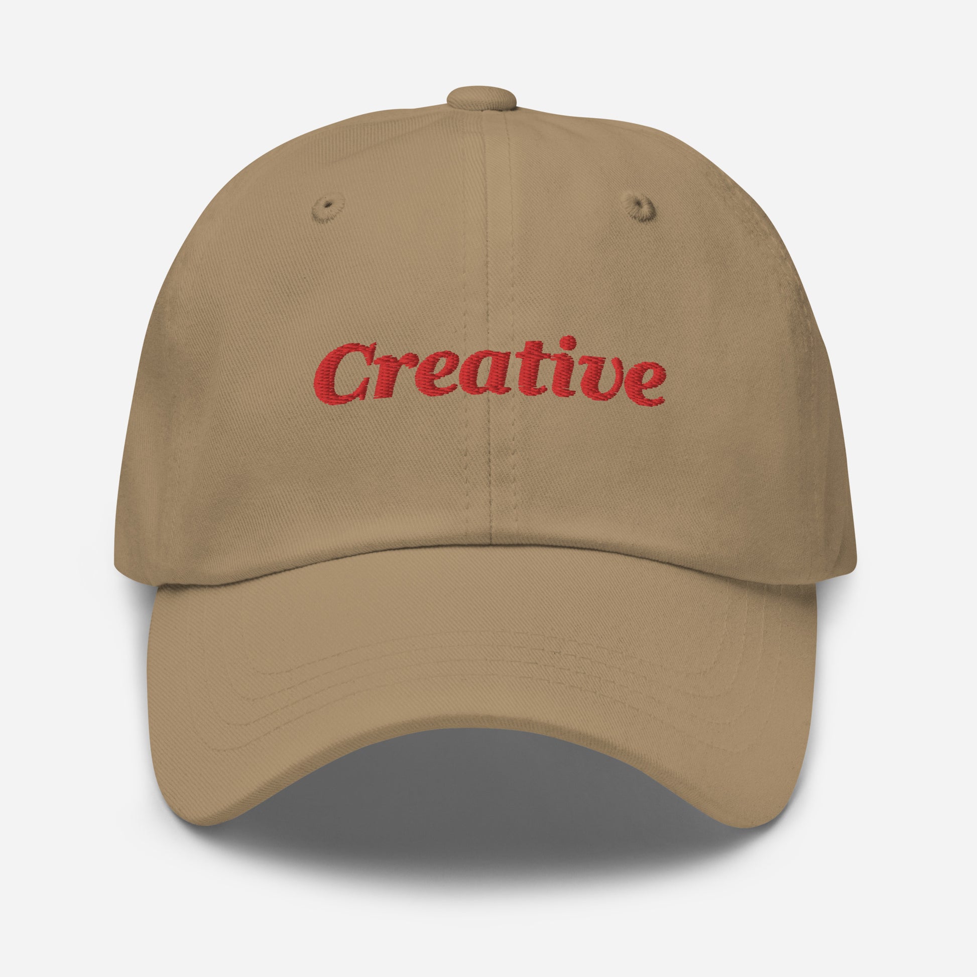 London city editions with “Creative” type in red embroidery on khaki casual dad hat front view on white background