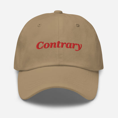 London city editions with “Contrary” type in red embroidery on khaki casual dad hat front view on white background