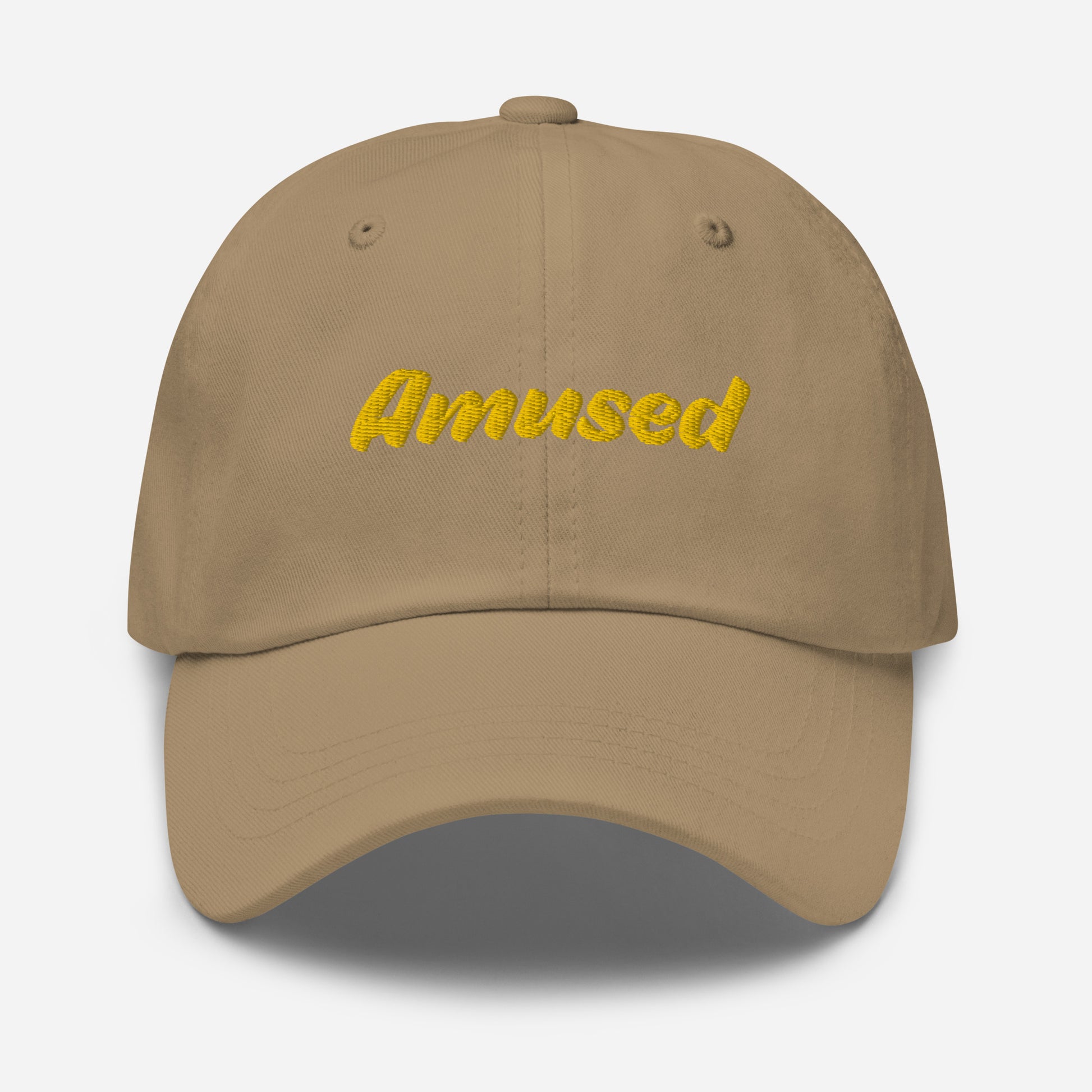 Austin city editions with “Amused” type in yellow embroidery on khaki casual dad hat front view on white background