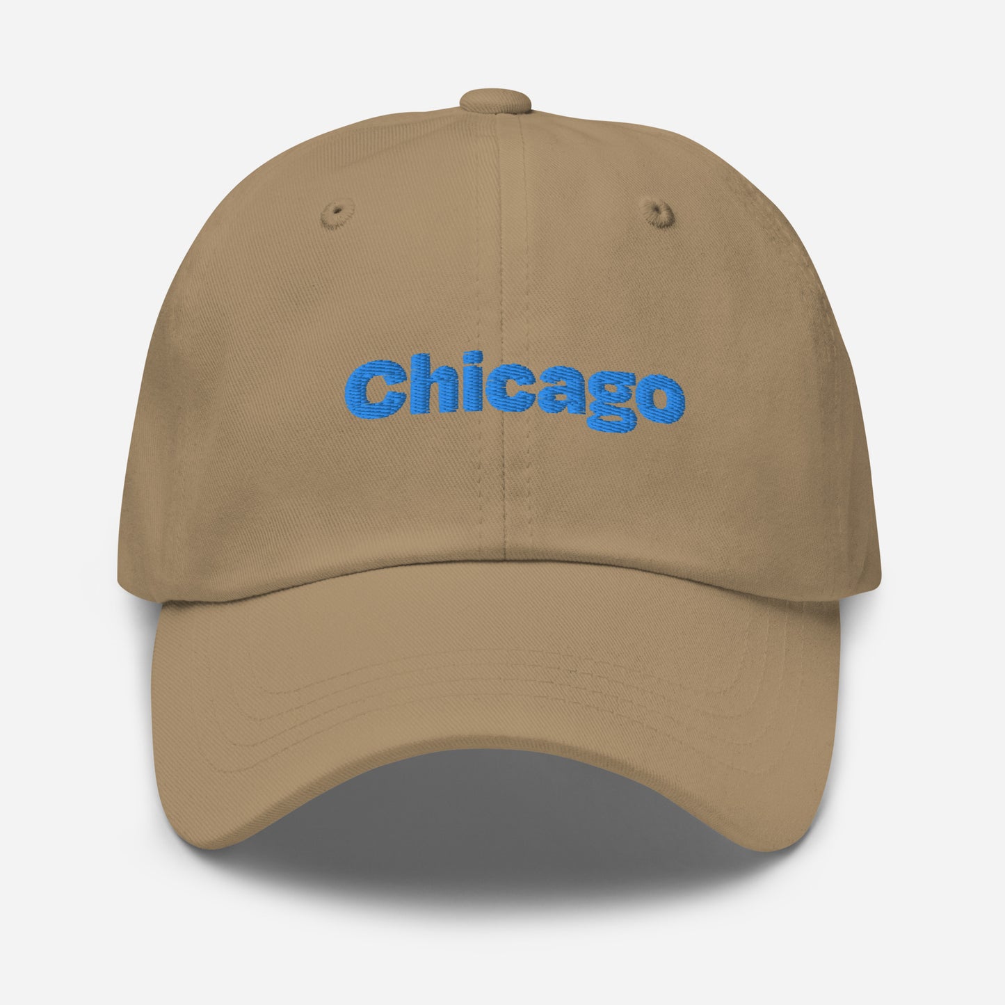 Chicago city editions with “Chicago” type in blue embroidery on khaki casual dad hat front view on white background