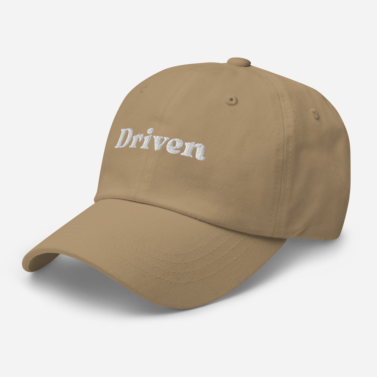 New York city editions with “Driven” type in white embroidery on khaki casual dad hat front side view on white background