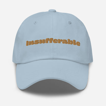 Los Angeles city editions with “Insufferable” type in gold embroidery on light blue casual dad hat front view on white background