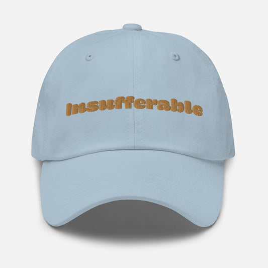 Los Angeles city editions with “Insufferable” type in gold embroidery on light blue casual dad hat front view on white background