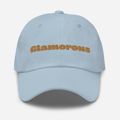 Los Angeles city editions with “Glamorous” type in gold embroidery on light blue casual dad hat front view on white background