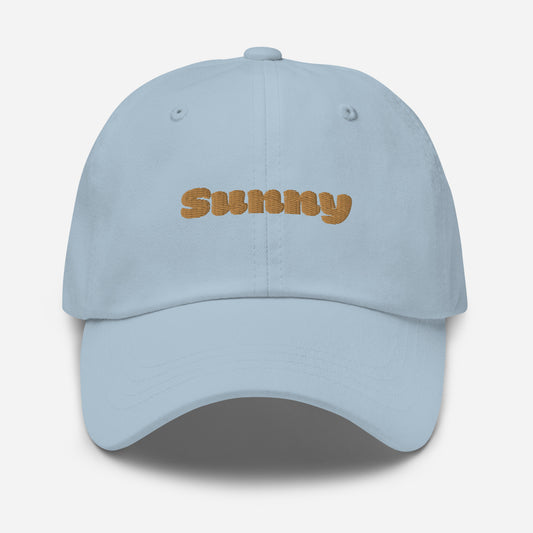 Los Angeles city editions with “Sunny” type in gold embroidery on light blue casual dad hat front view on white background