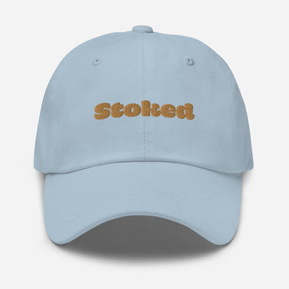 Los Angeles city editions with “Stoked” type in gold embroidery on light blue casual dad hat front view on white background