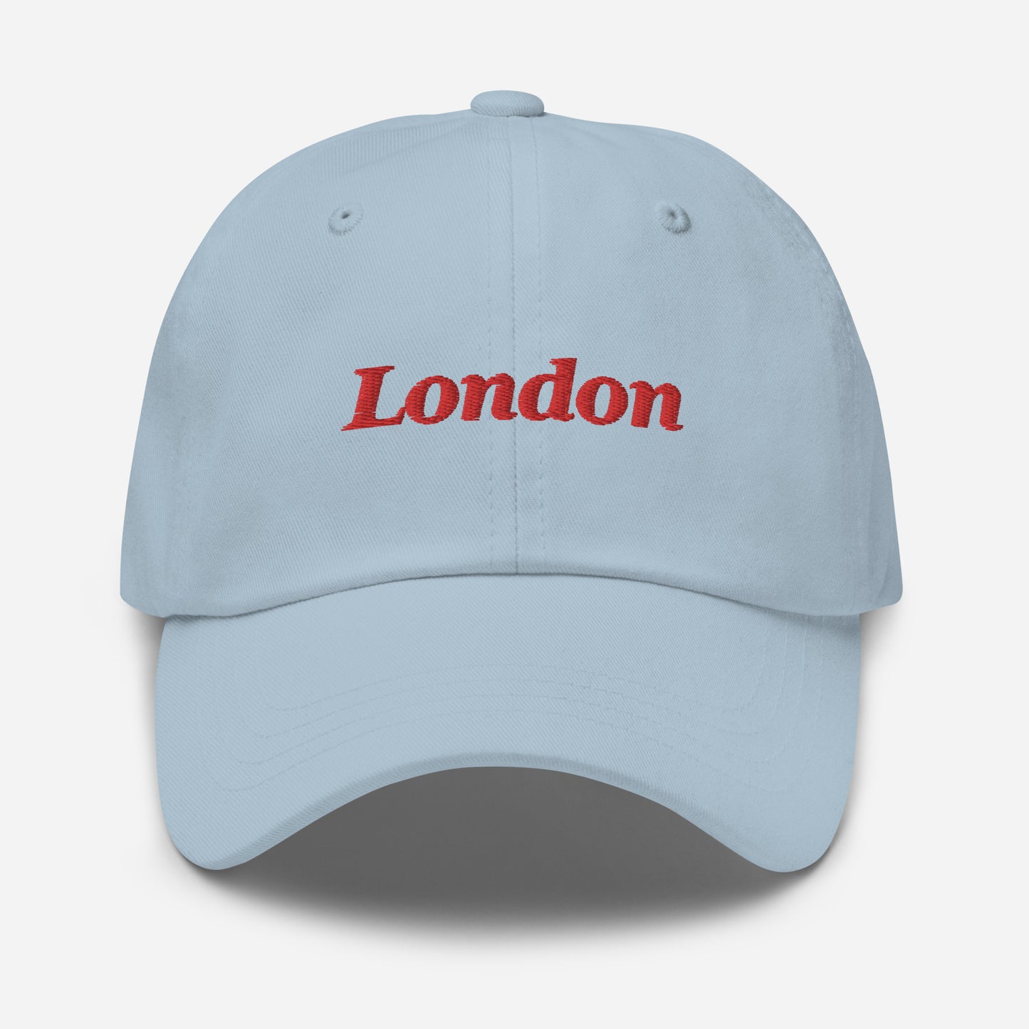 London city editions with “London” type in red embroidery on light blue casual dad hat front view on white background