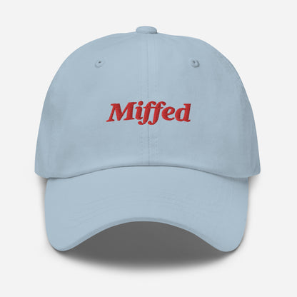 London city editions with “Miffed” type in red embroidery on light blue casual dad hat front view on white background