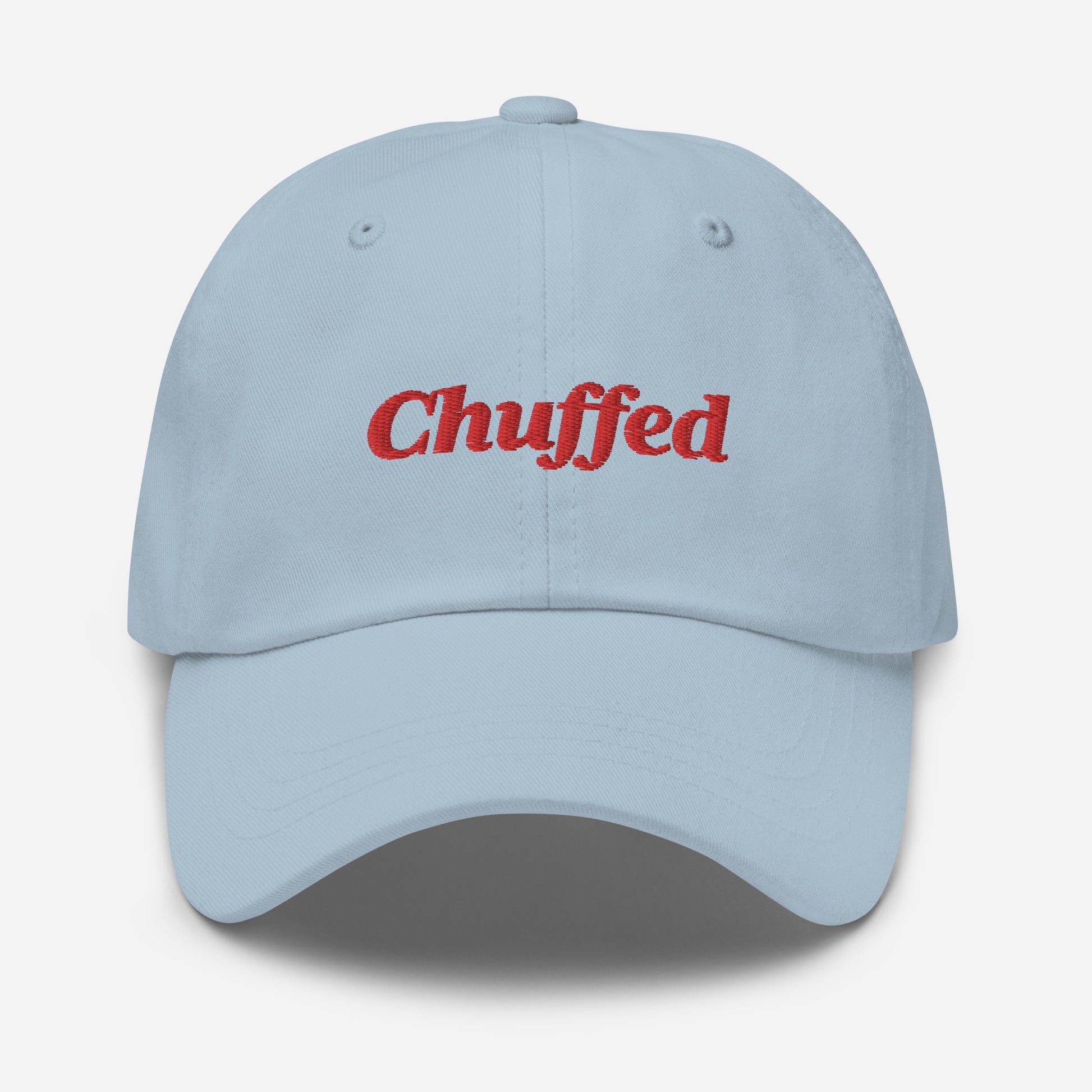 London city editions with “Chuffed” type in red embroidery on light blue casual dad hat front view on white background