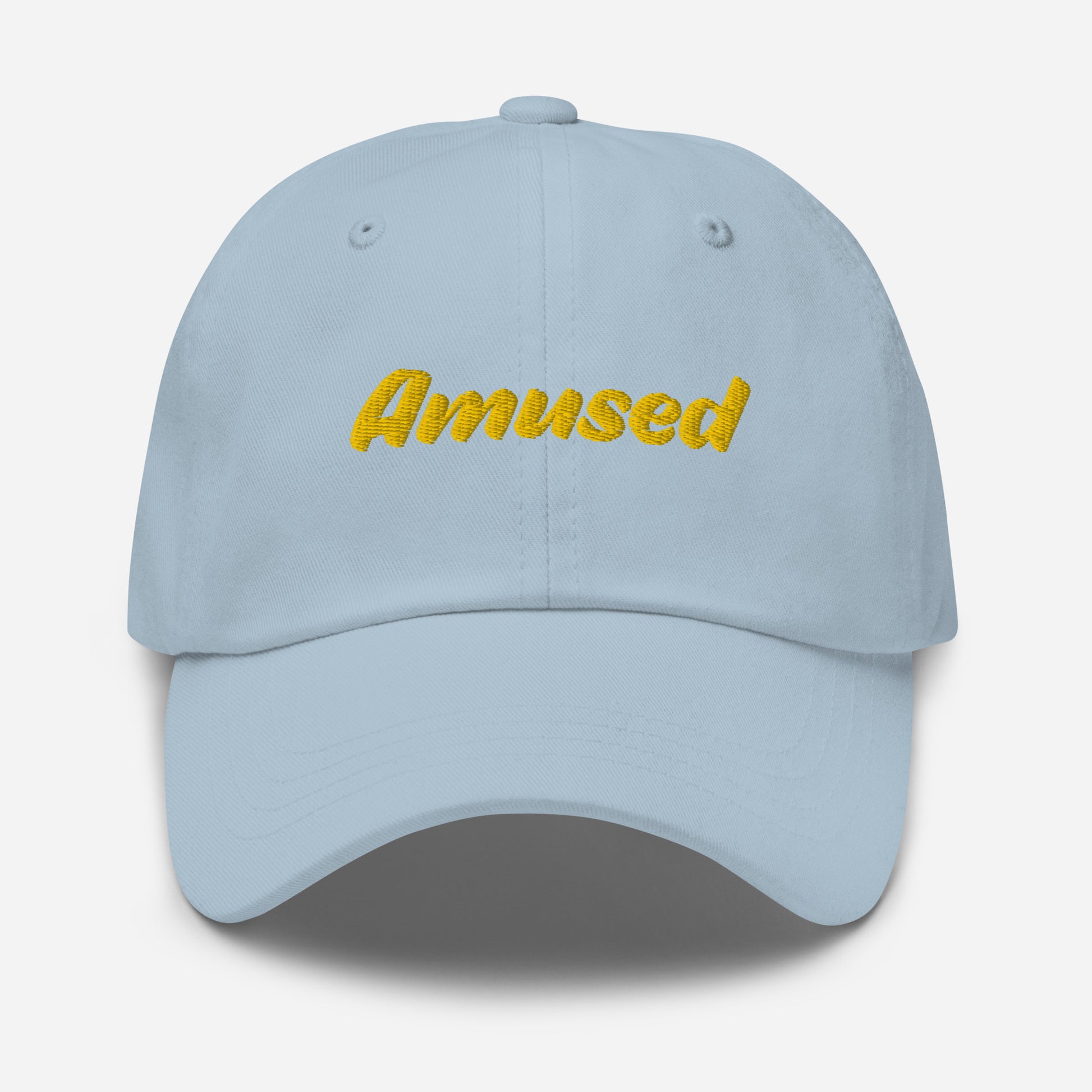 Austin city editions with “Amused” type in yellow embroidery on light blue casual dad hat front view on white background