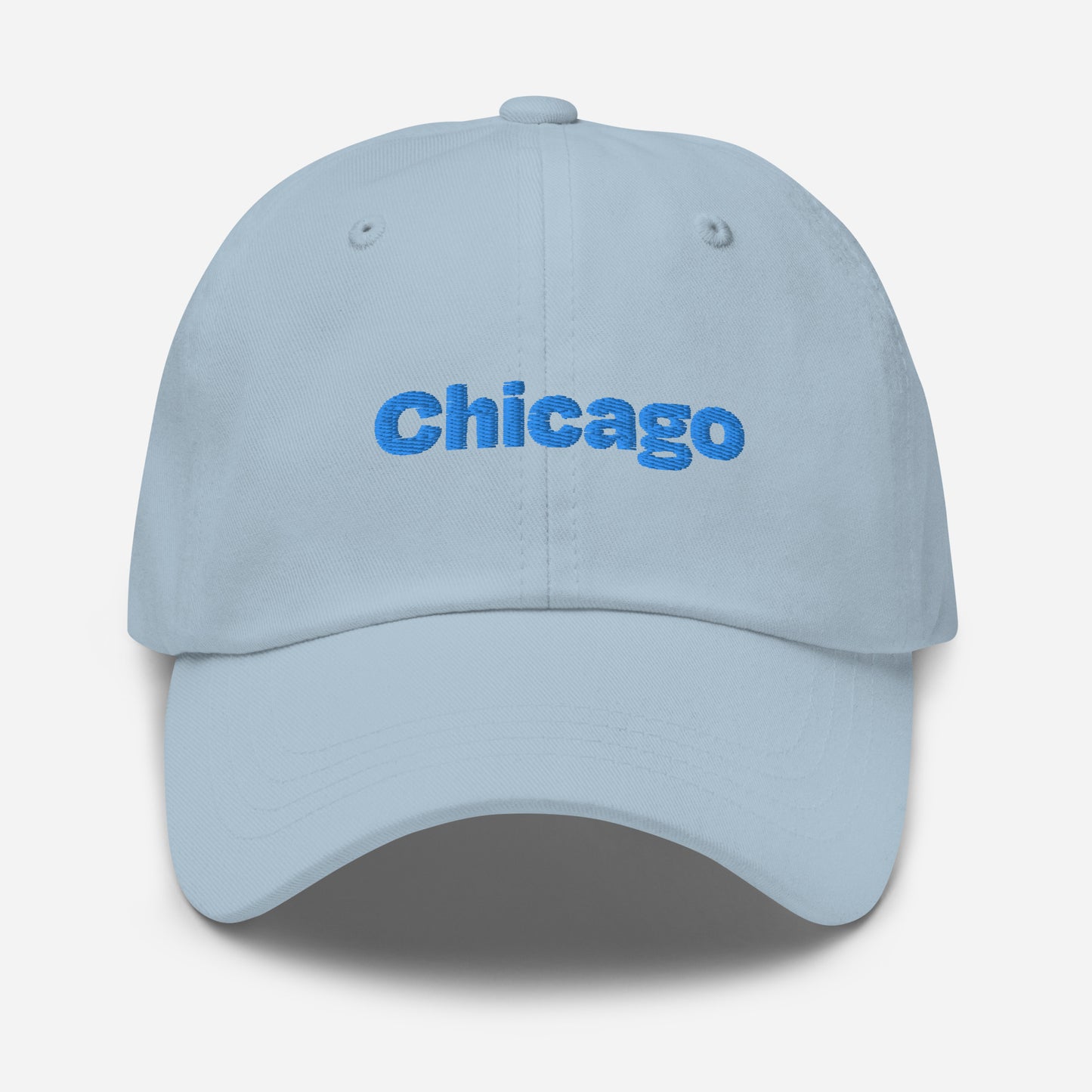 Chicago city editions with “Chicago” type in blue embroidery on light blue casual dad hat front view on white background