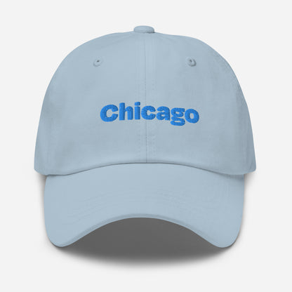 Chicago city editions with “Chicago” type in blue embroidery on light blue casual dad hat front view on white background