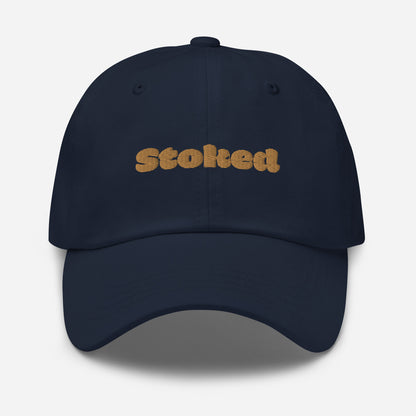 Los Angeles city editions with “Stoked” type in gold embroidery on navy casual dad hat front view on white background