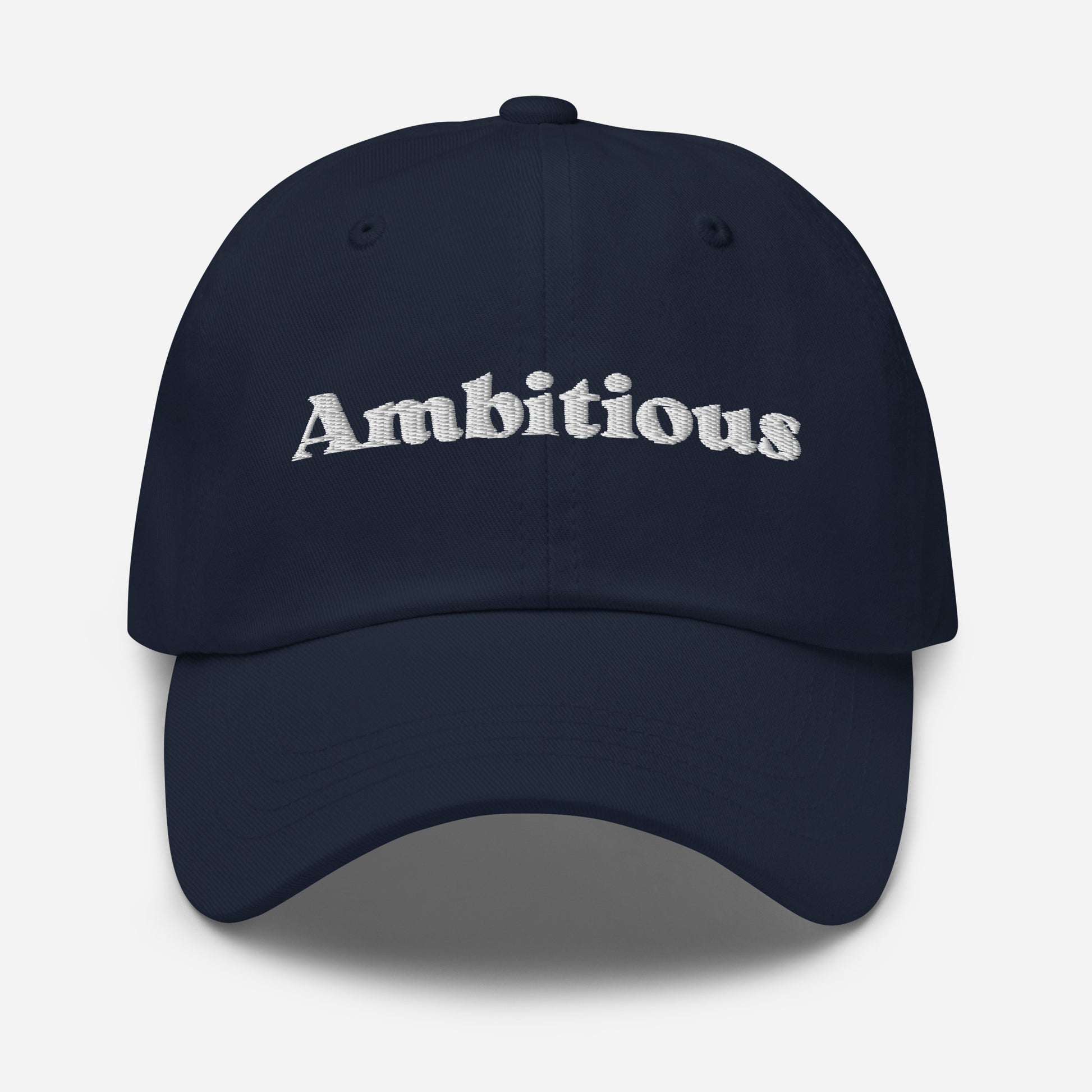 New York city editions with “Ambitious” type in white embroidery on navy casual dad hat front view on white background