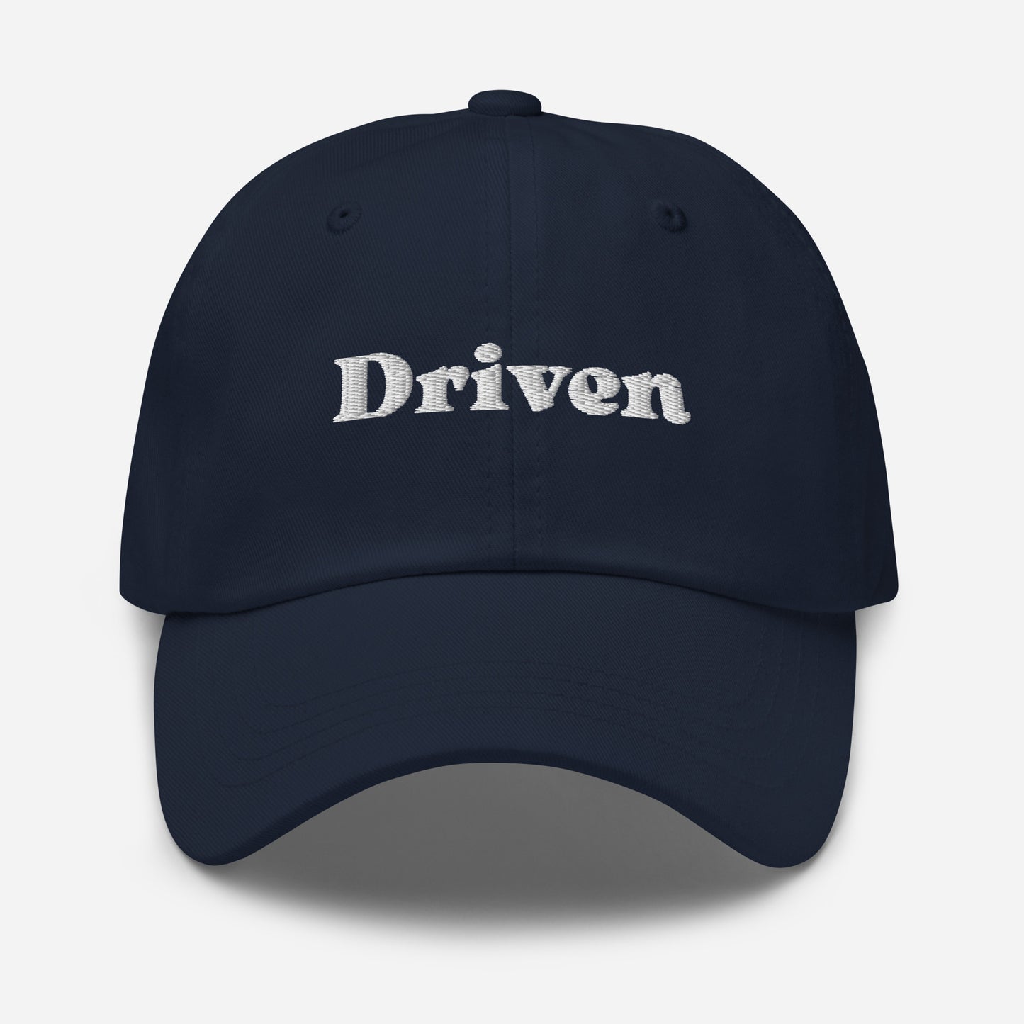 New York city editions with “Driven” type in white embroidery on navy casual dad hat front view on white background