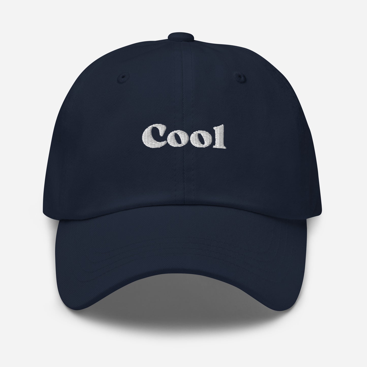 New York city editions with “Cool” type in white embroidery on navy casual dad hat front view on white background