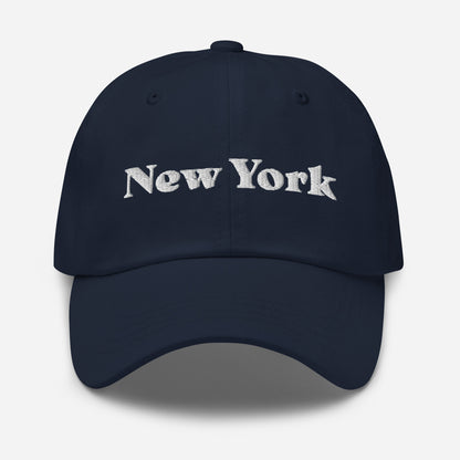 New York city editions with “New York” type in white embroidery on navy casual dad hat front view on white background